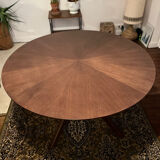 Round table made of solid wood with a walnut finish top.