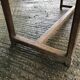 Old chestnut table with 3 front drawers and a cat bar.