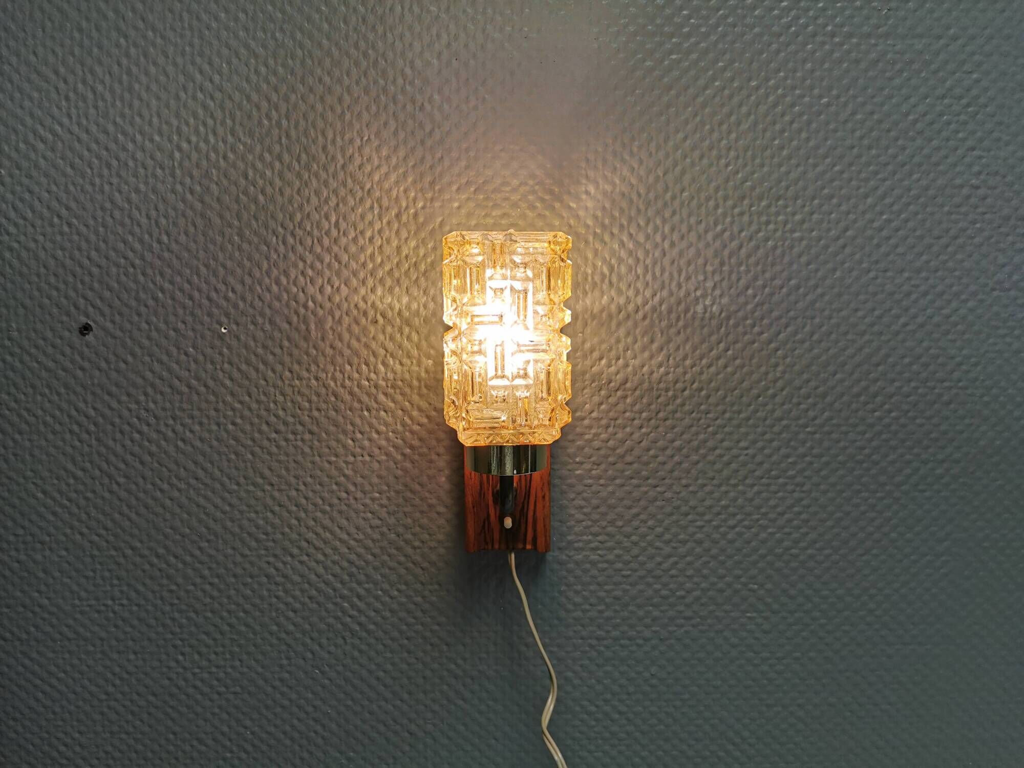 Small, stylish wall lamp with rosewood suspension and hard pressed glass