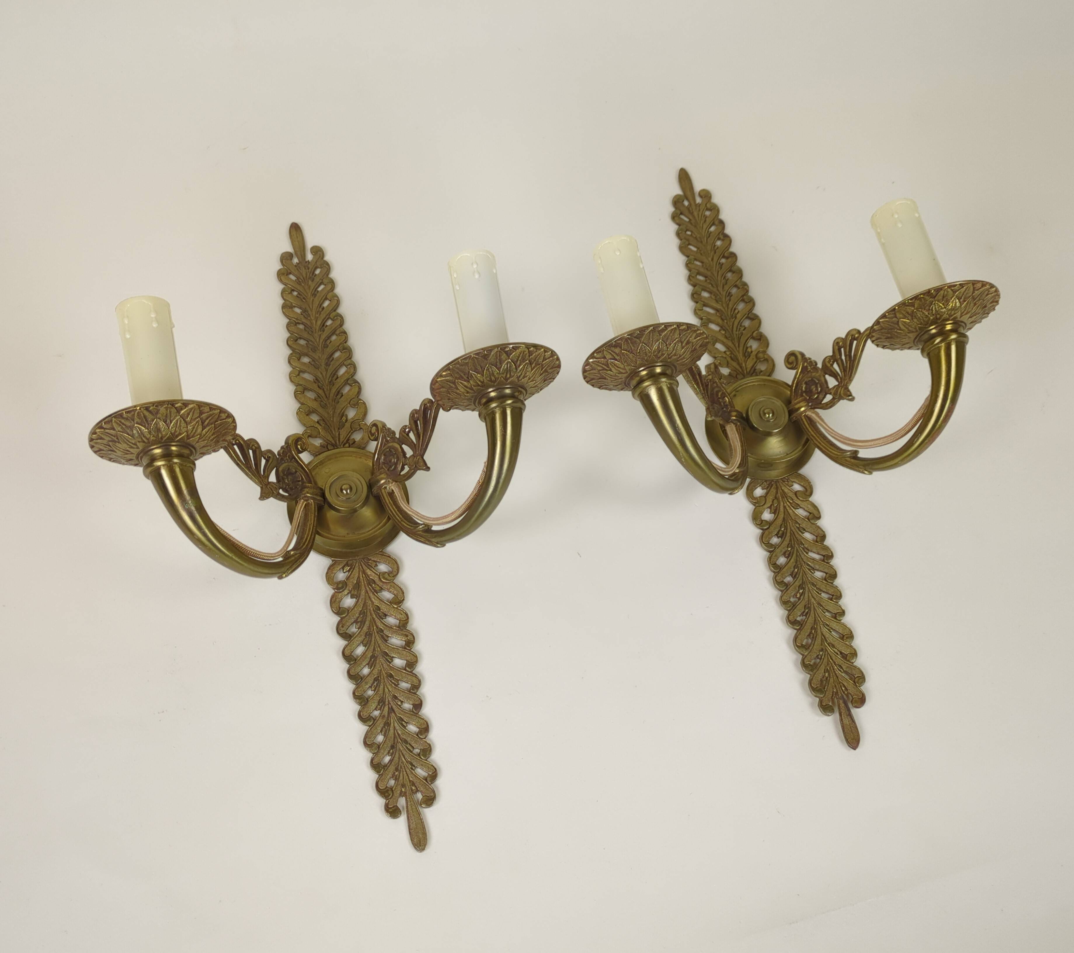 Pair of two-armed Empire wall sconces in gilded bronze