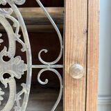 Column storage unit with a sculpted metal door.