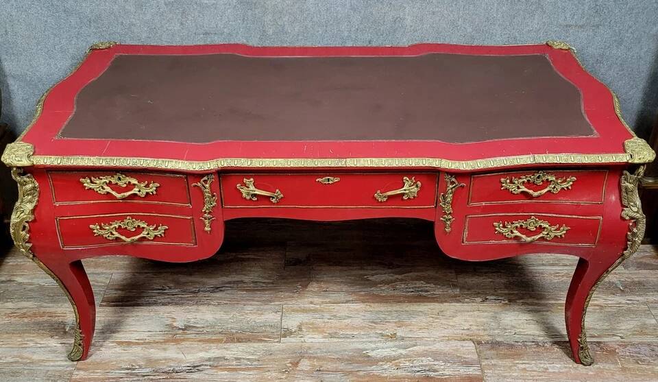 Louis XV style curved center desk in red lacquer and gilded bronze