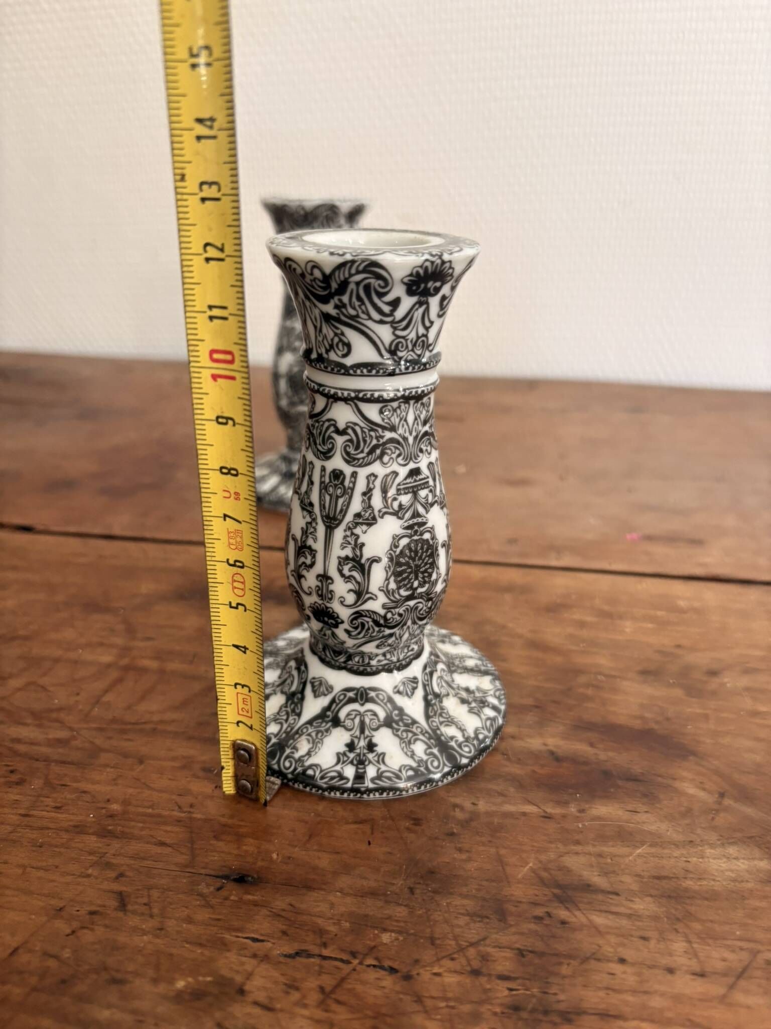 Pair of White and Black Porcelain Candle Holders with Berain Scroll Decoration, Baluster Style