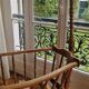 Wooden cradle in walnut with a sign collar at the top.