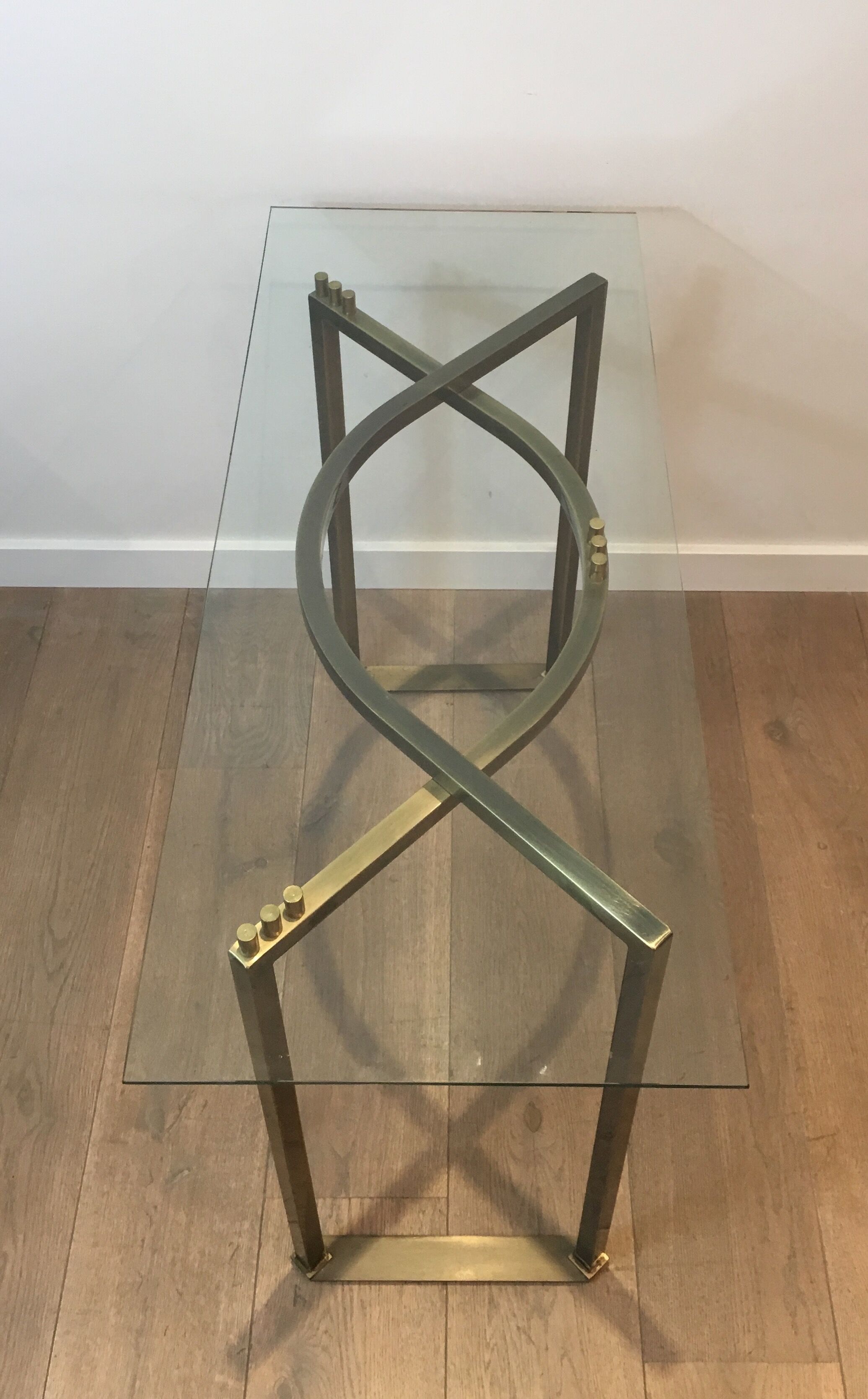 Console in brushed steel and brass and tray formed of a glass slab. French work. Around 1970