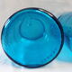 pair of apothecary vials in blue glass jar