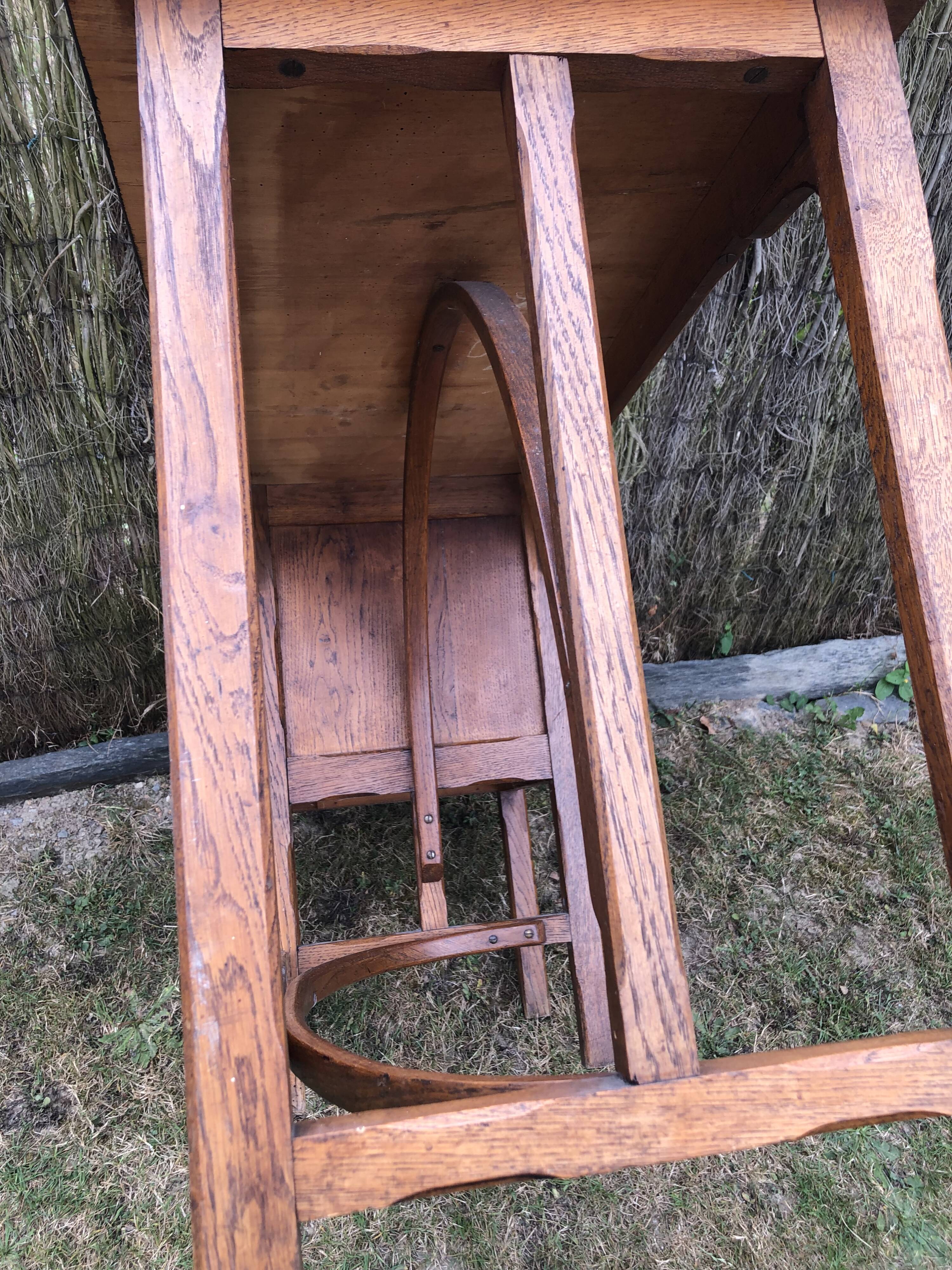 Old oak desk with curved wooden sleepers in the Art Nouveau spirit of the early 20th century.