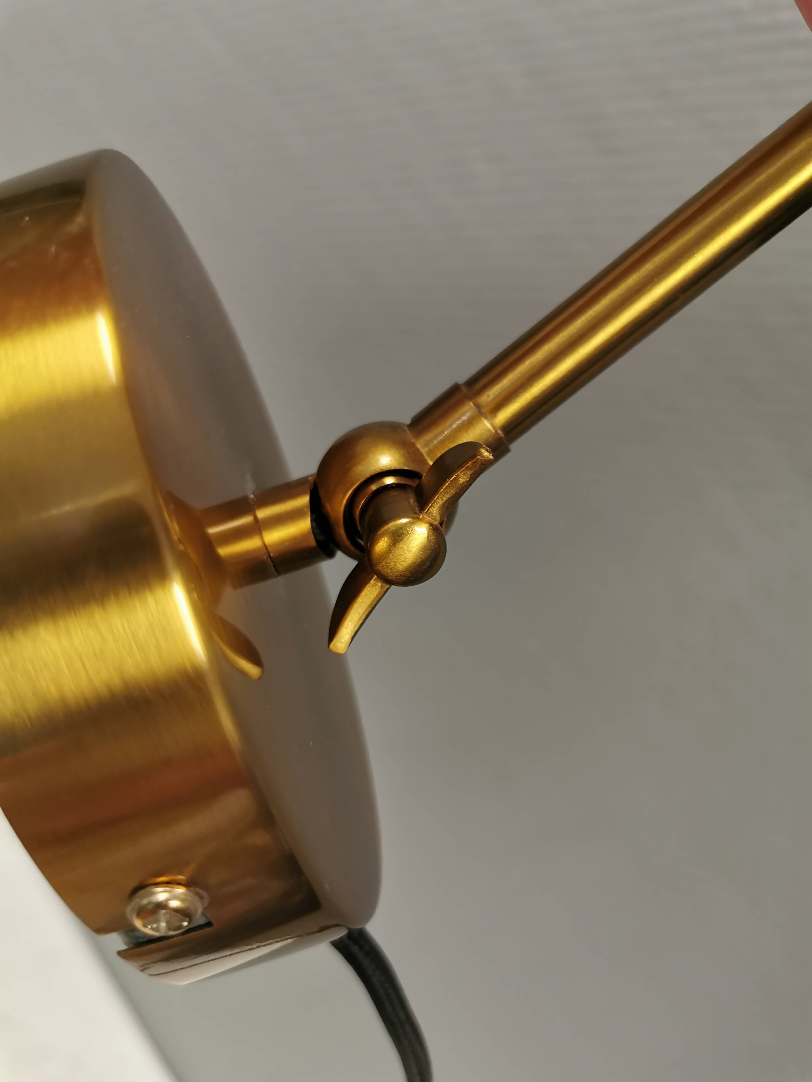A wall lamp in black and brass-coloured finishes. Danish, early 2000s.