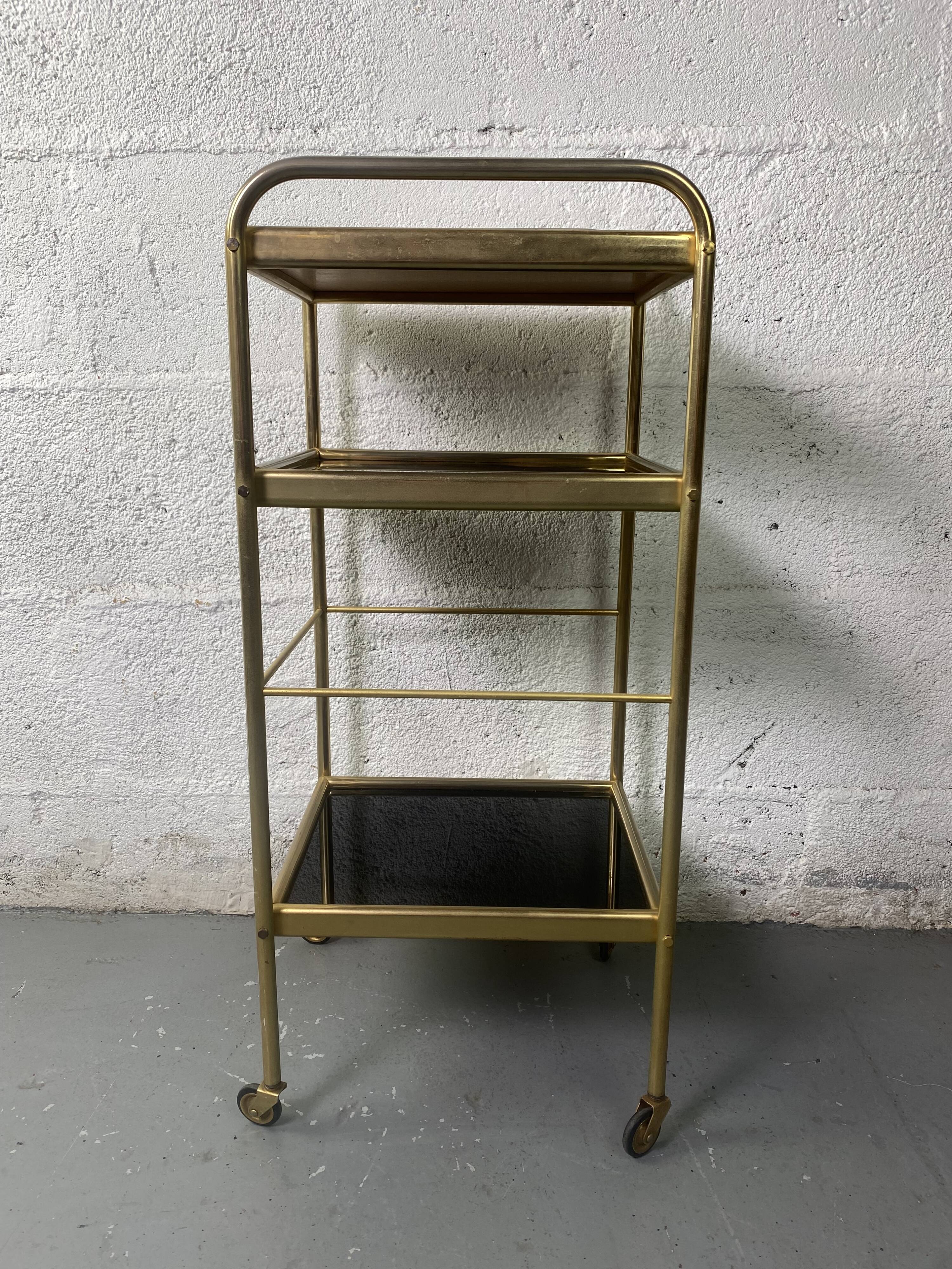 Small rolling trolley in brass and black plastic