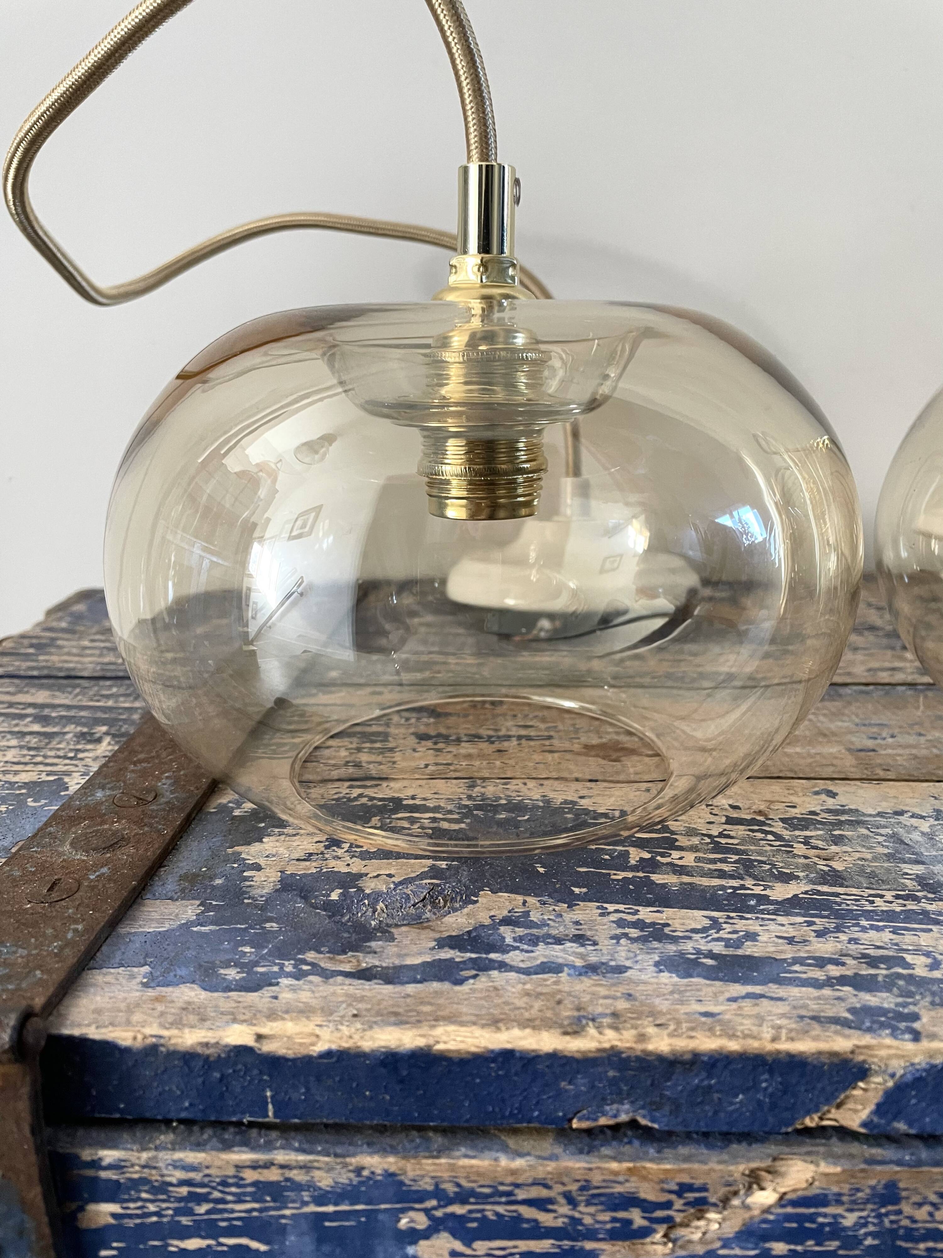 Set of three new electrified golden glass pendant lamps
