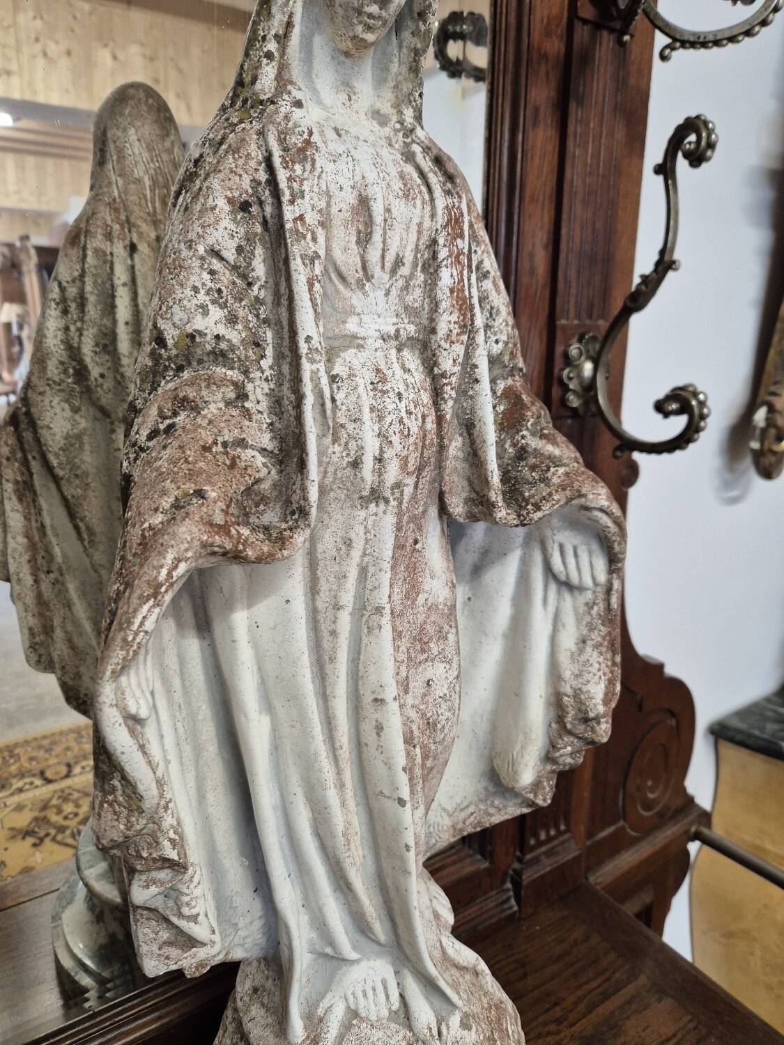 Garden statue of the Virgin Mary in old reconstituted stone
