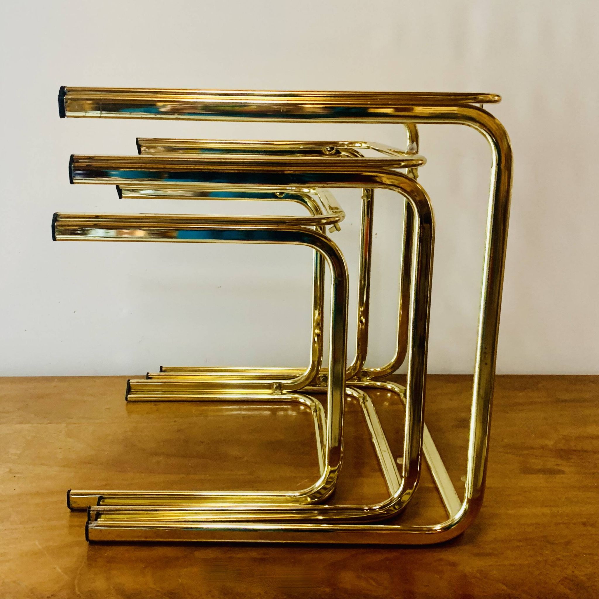Vintage nesting tables in gold metal and smoked glass