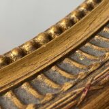 Oval-shaped wooden mirror in gold color