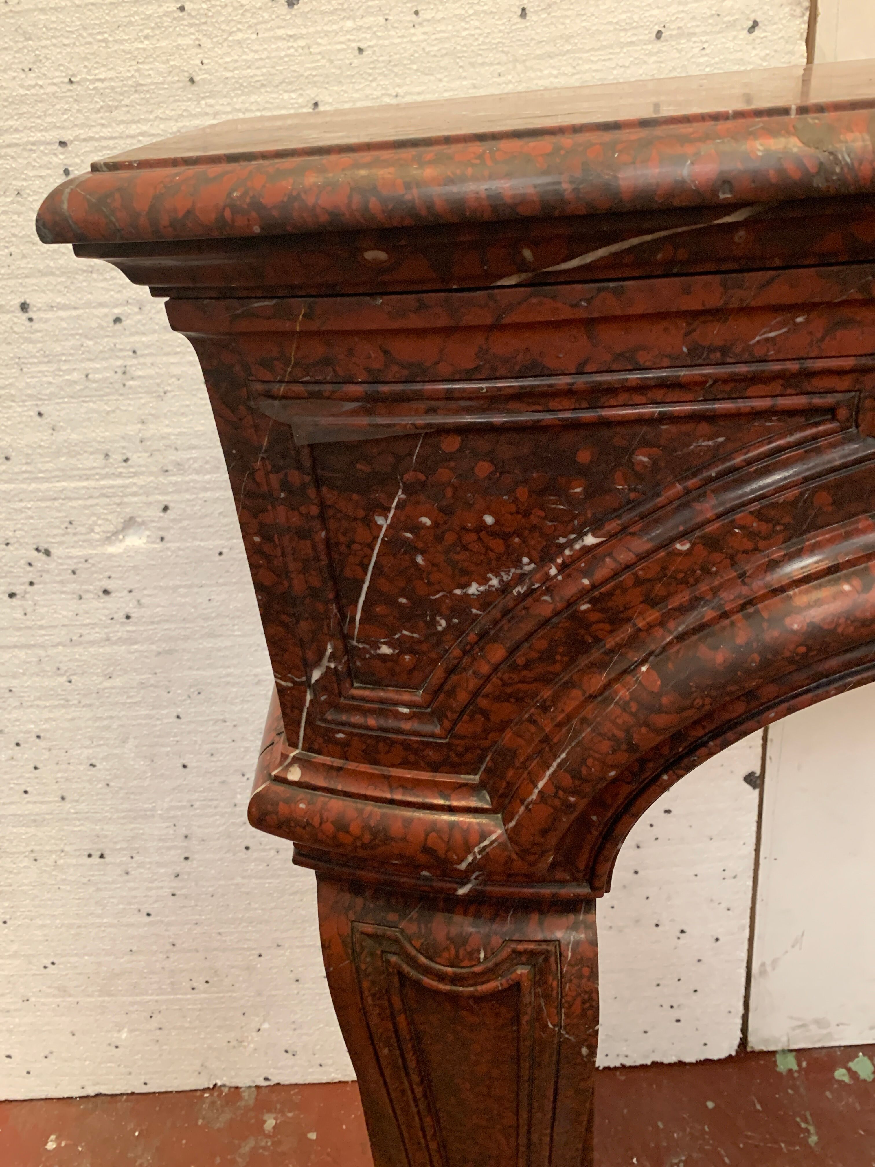 Pair of Louis XIV style fireplaces in red cherry marble. XIX century.