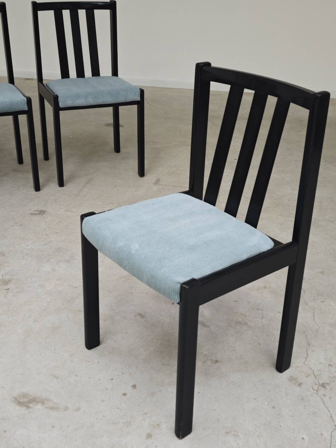 Set of 4 modernist black chairs with light blue ribbed fabric