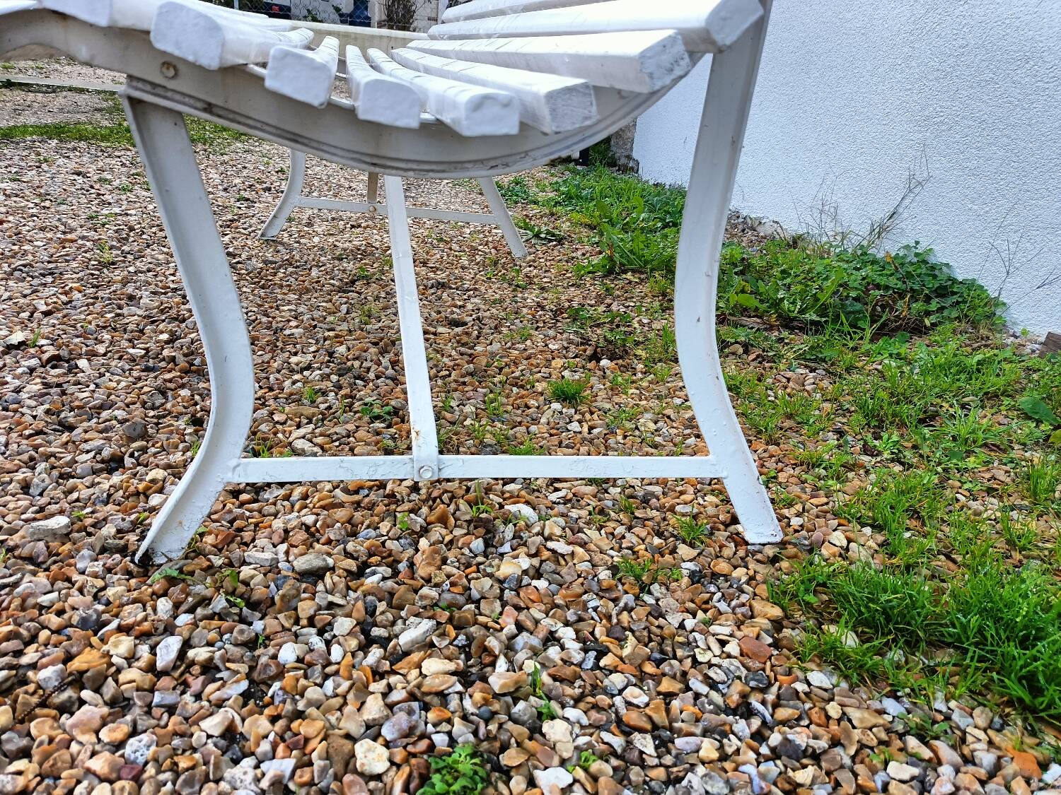 Old garden bench with metal legs and wooden slats