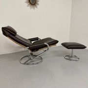 Vintage leather reclining armchair and its 1970s designer ottoman.
