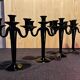 Set of four black glass candle holders.