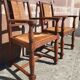 Pair of oak armchairs with straw seats and backs.