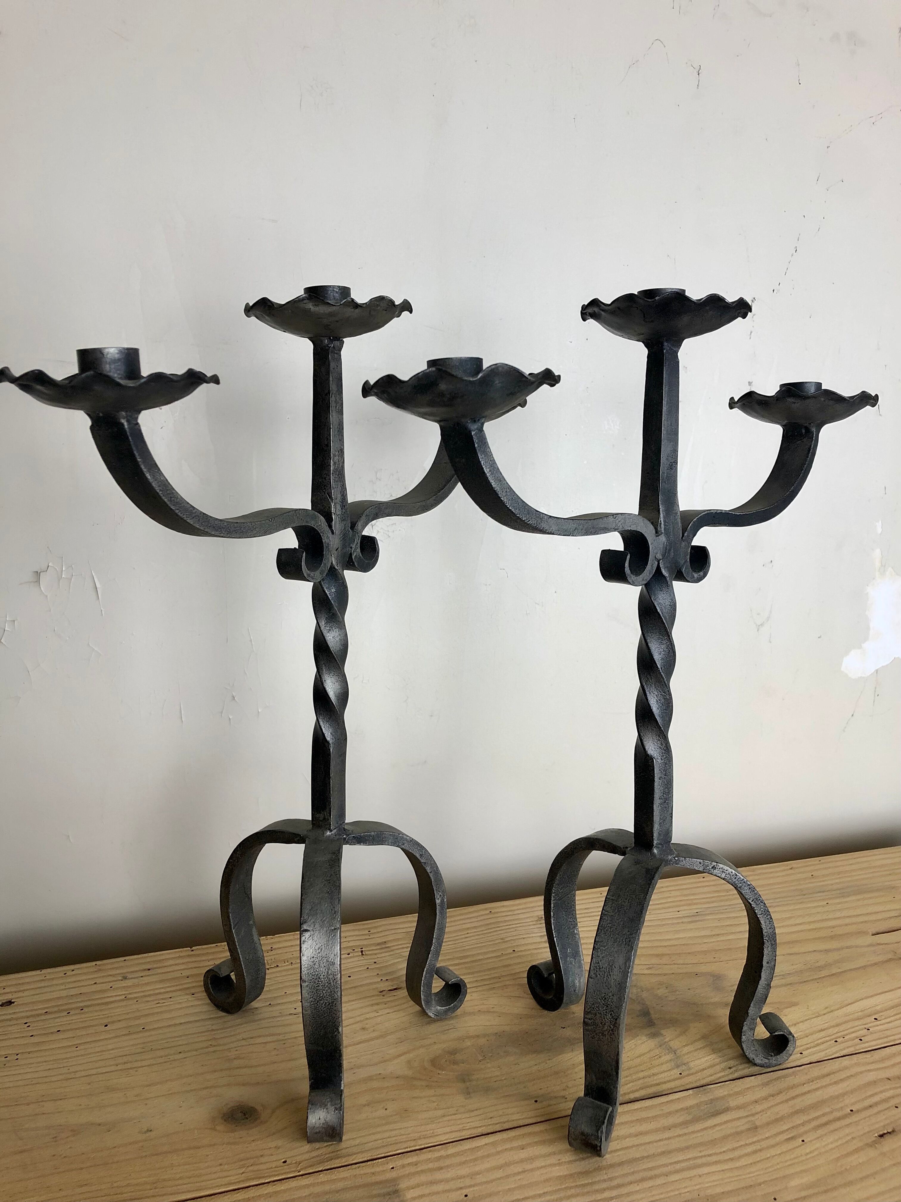 Pair of wrought iron candlesticks