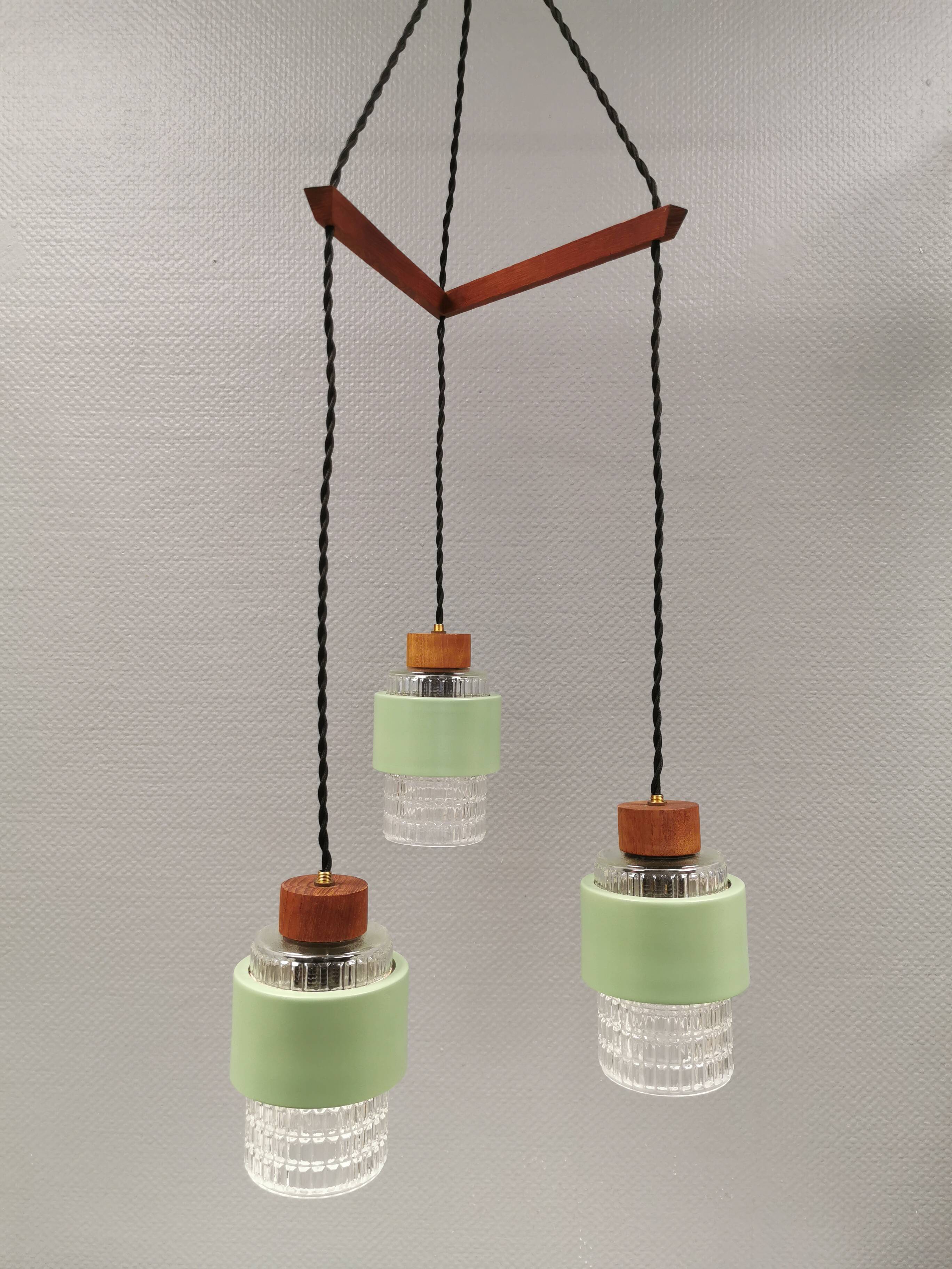 Three-part pendant in crystal glass, teak wood, and thin dusty green metal