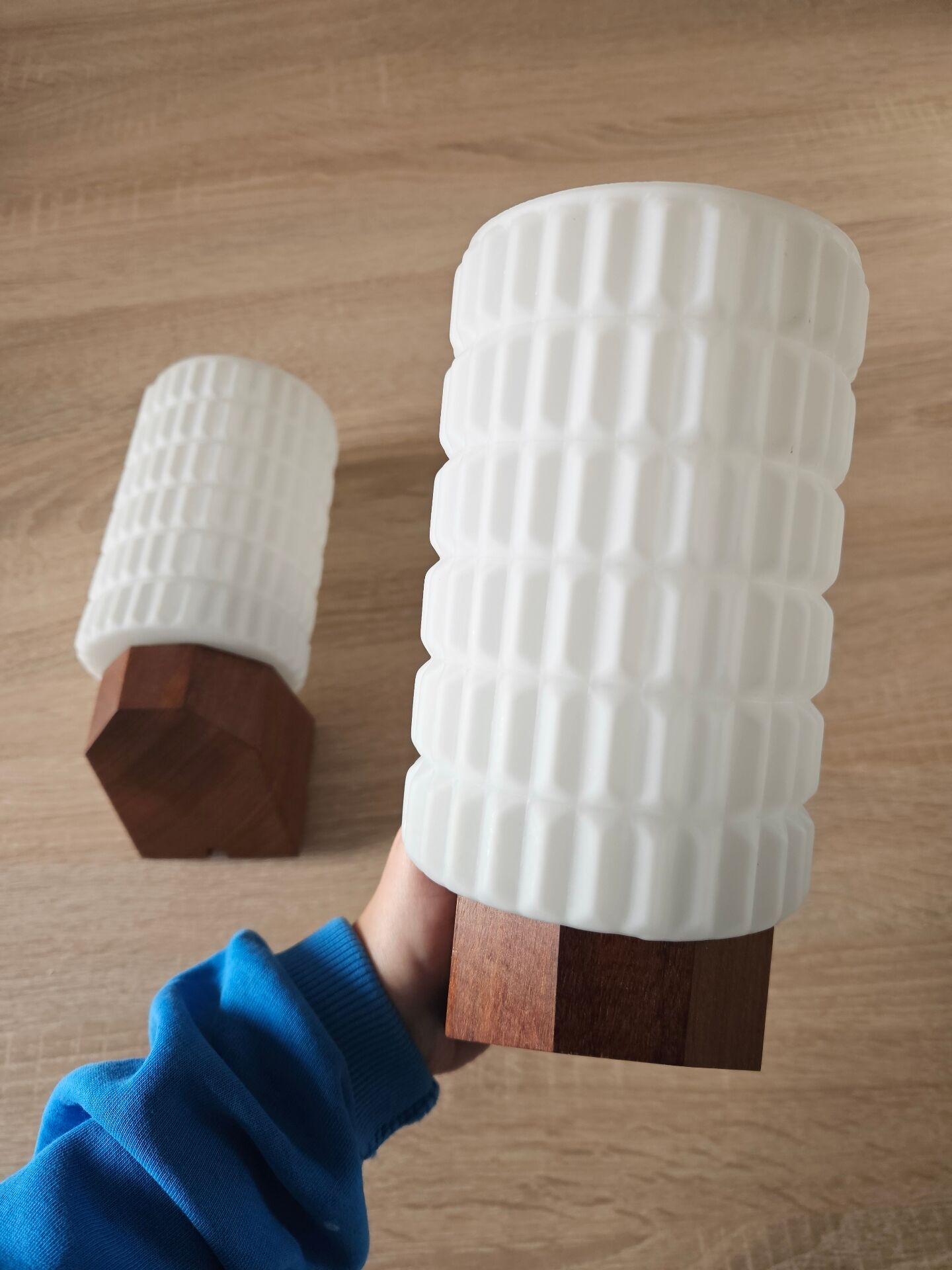 Philips wall sconces in wood and white opal.