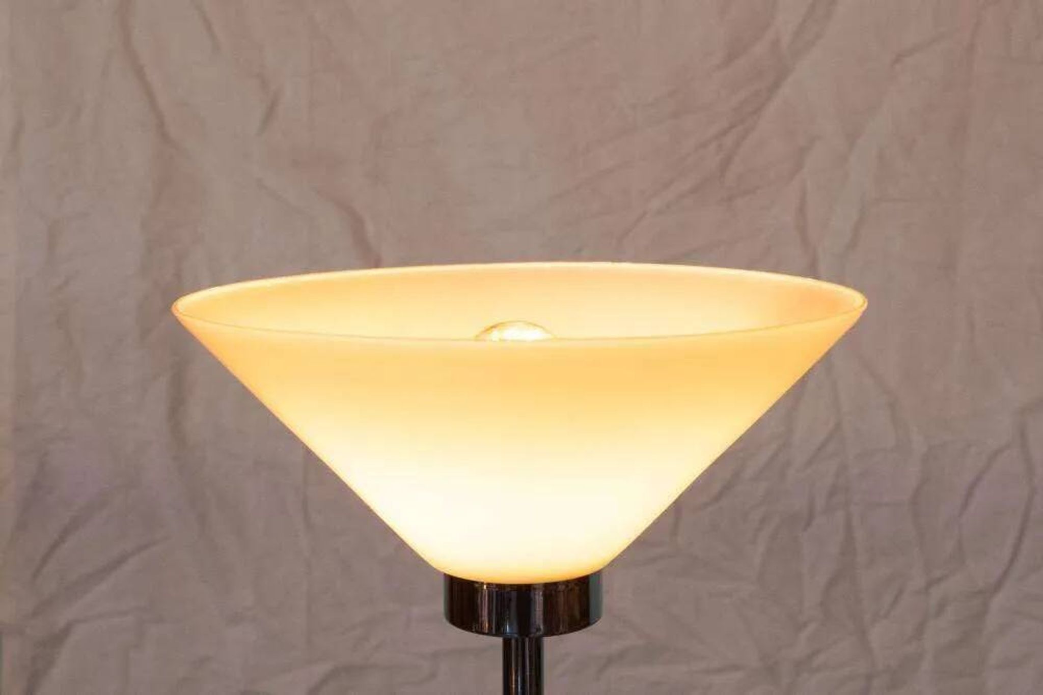 Vintage floor lamp in milky glass and chrome, minimalist uplight lighting.