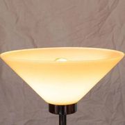 Vintage floor lamp in milky glass and chrome, minimalist uplight lighting.