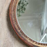 Old oval mirror in gilded wood