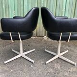 Pair of vintage armchairs in black skai with metal legs.