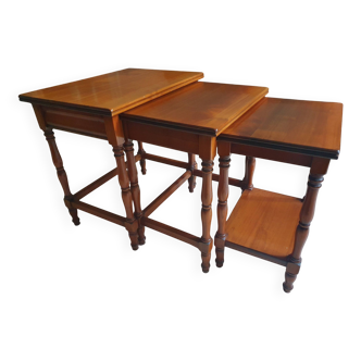 Nesting tables in solid cherry wood held together by slides