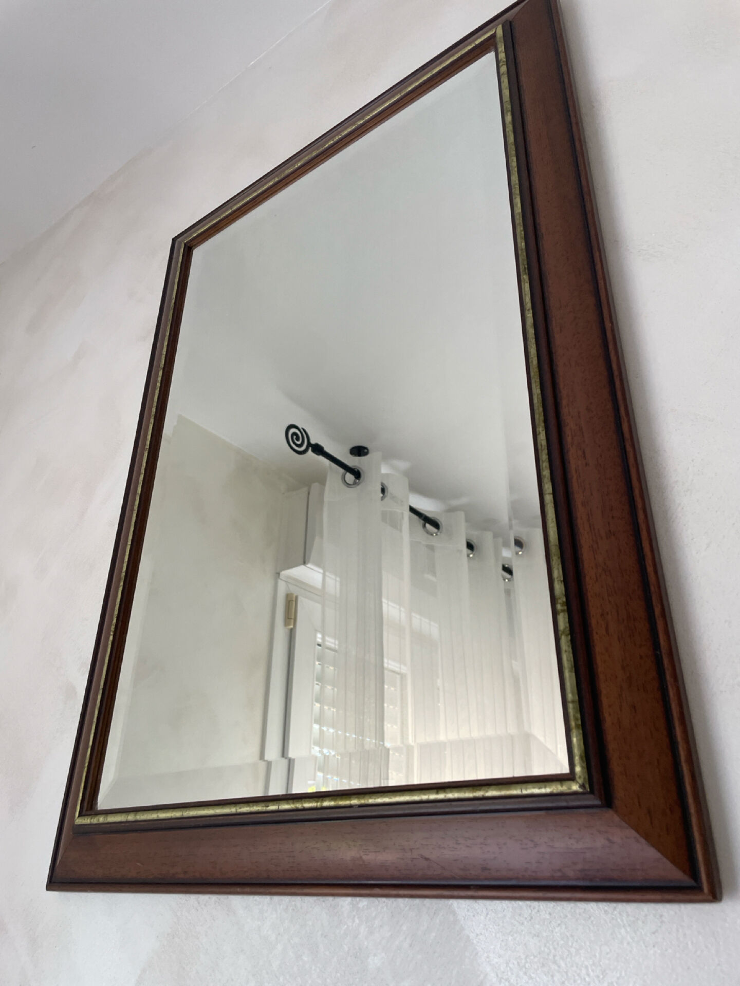 Vintage bevelled wall mirror in stained wood and brass