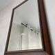 Vintage bevelled wall mirror in stained wood and brass