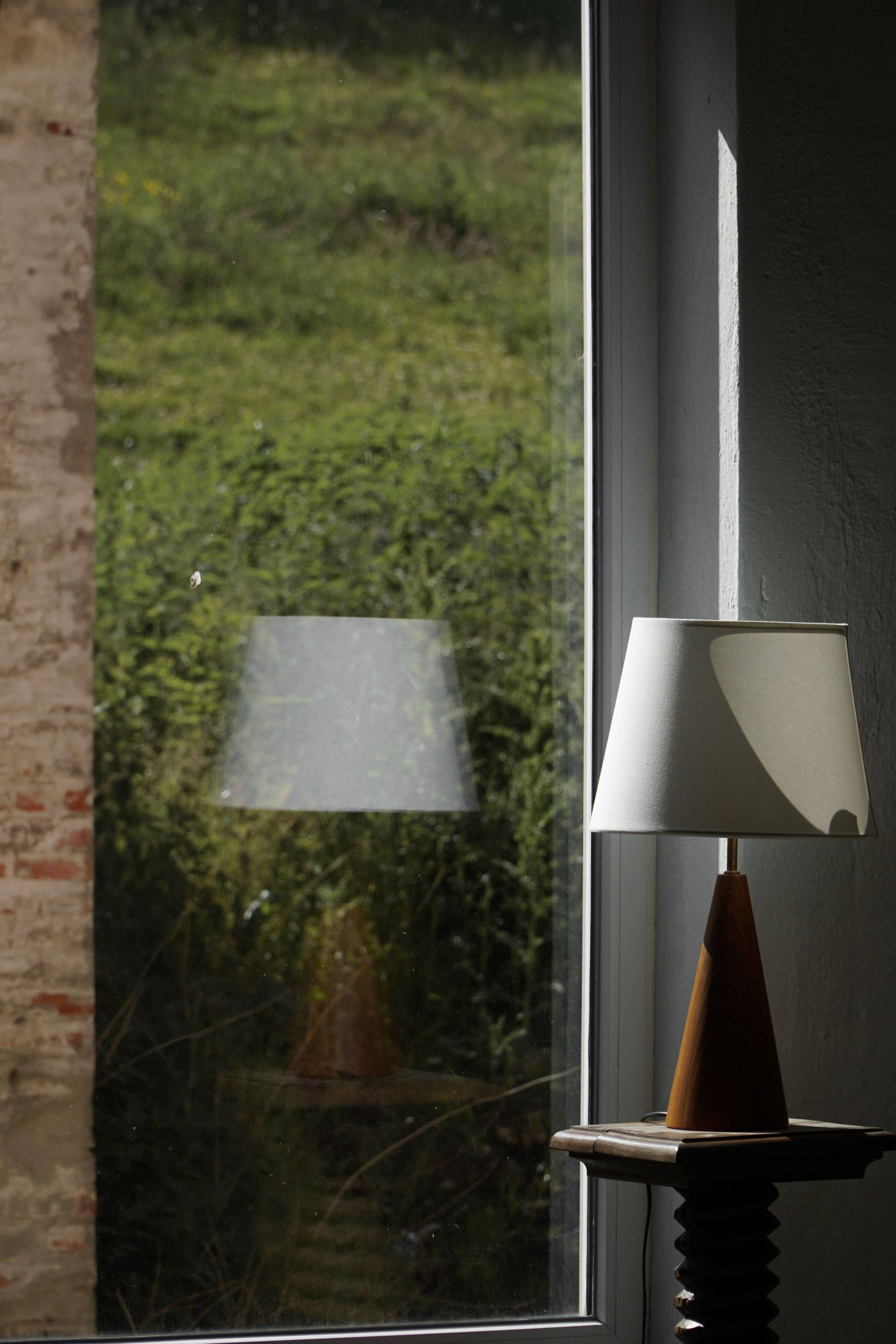 Modern Danish, a conical table lamp in teak, 1980s.