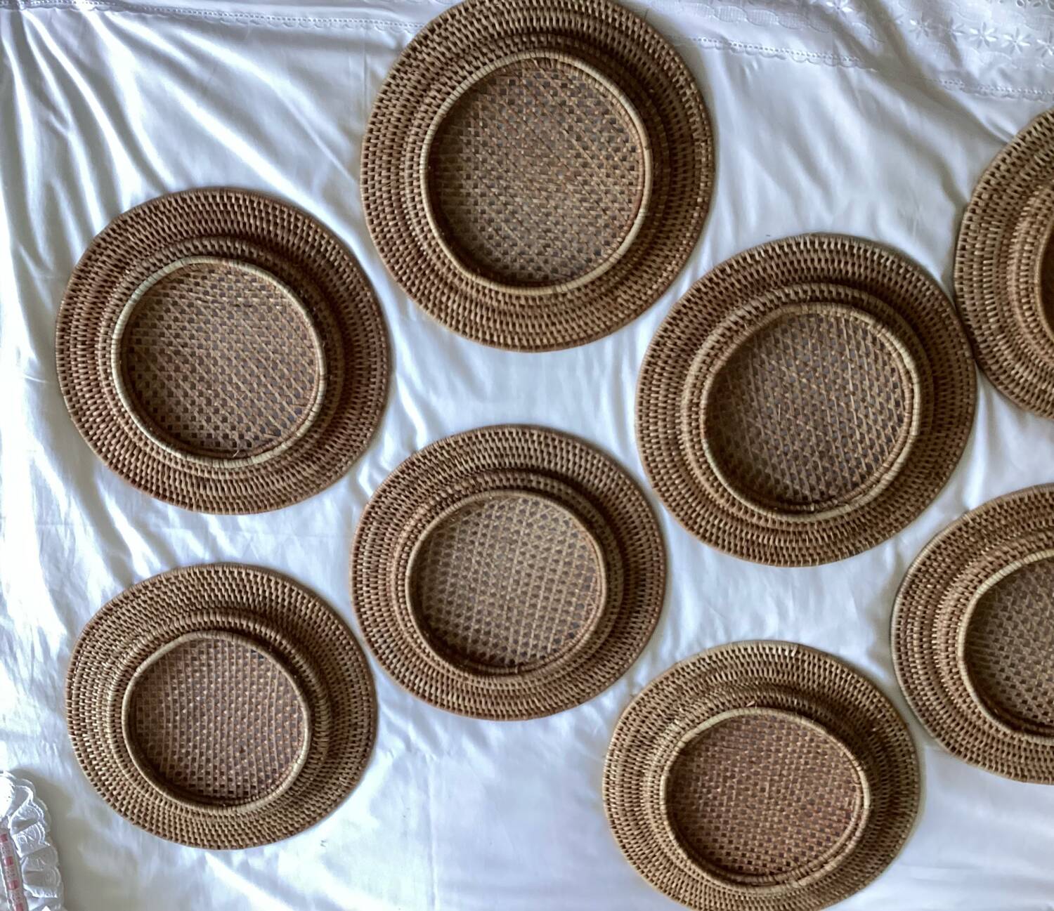 Set of round woven rattan and canework coasters