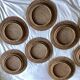 Set of round woven rattan and canework coasters