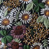 Embroidered black linen cushion