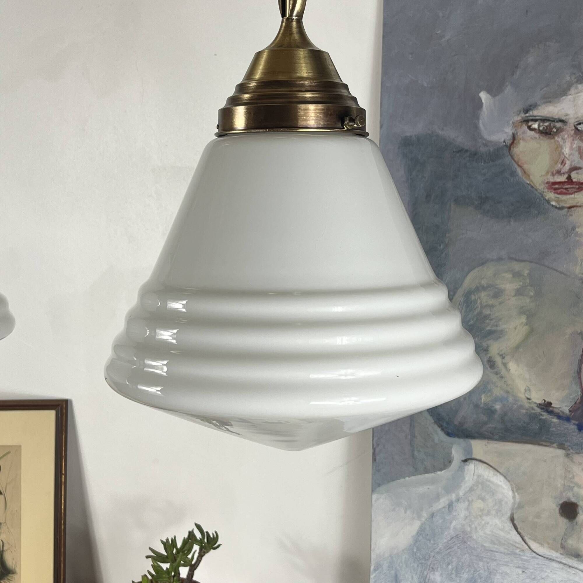 Pair of opaline glass pendant lights in white by Philips and brass from the 1920s.