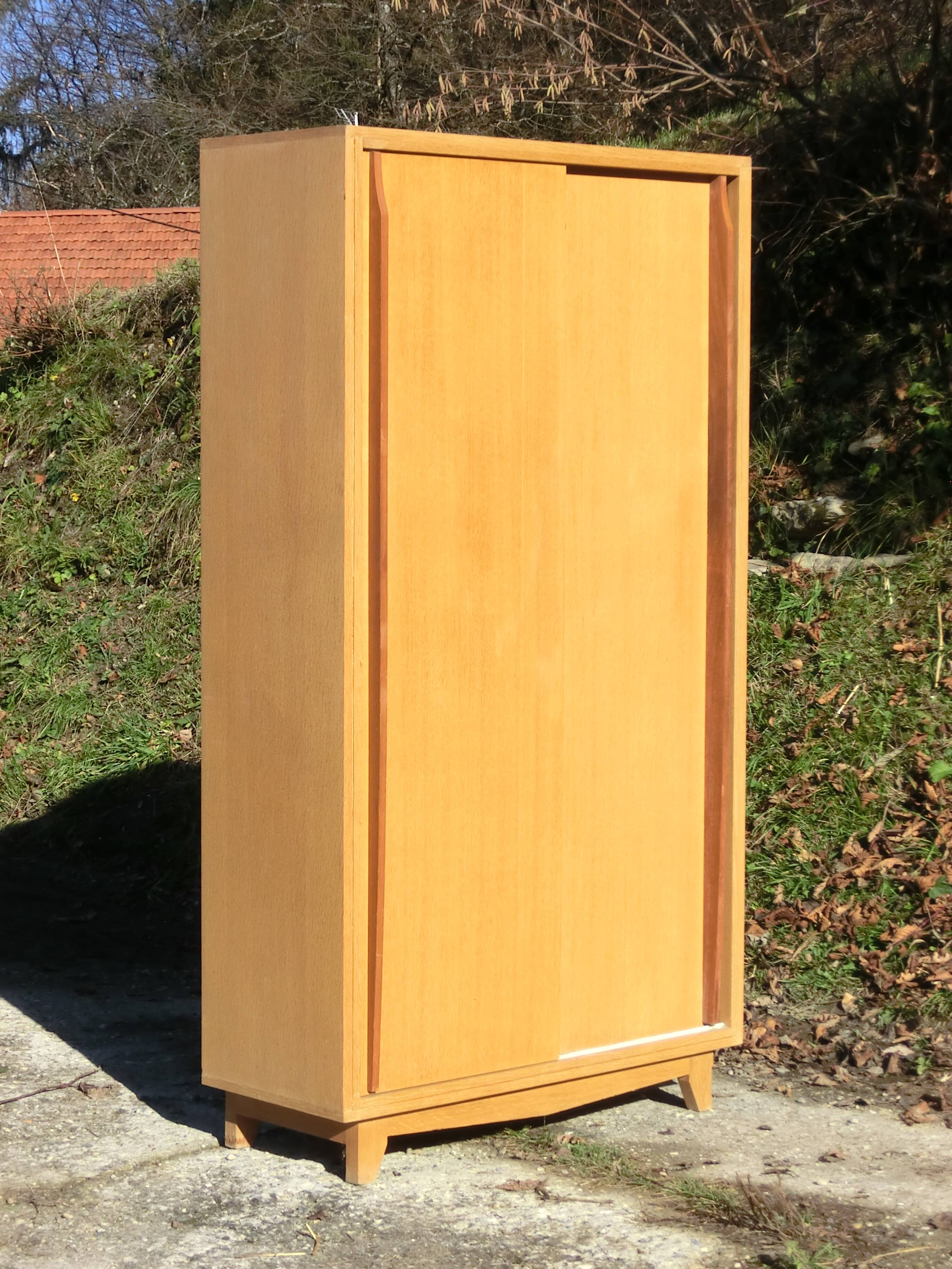 Small Scandinavian wardrobe with sliding doors - 1 side for hanging clothes.