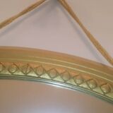 Oval mirror in wood and gilded plaster with pompom decoration
