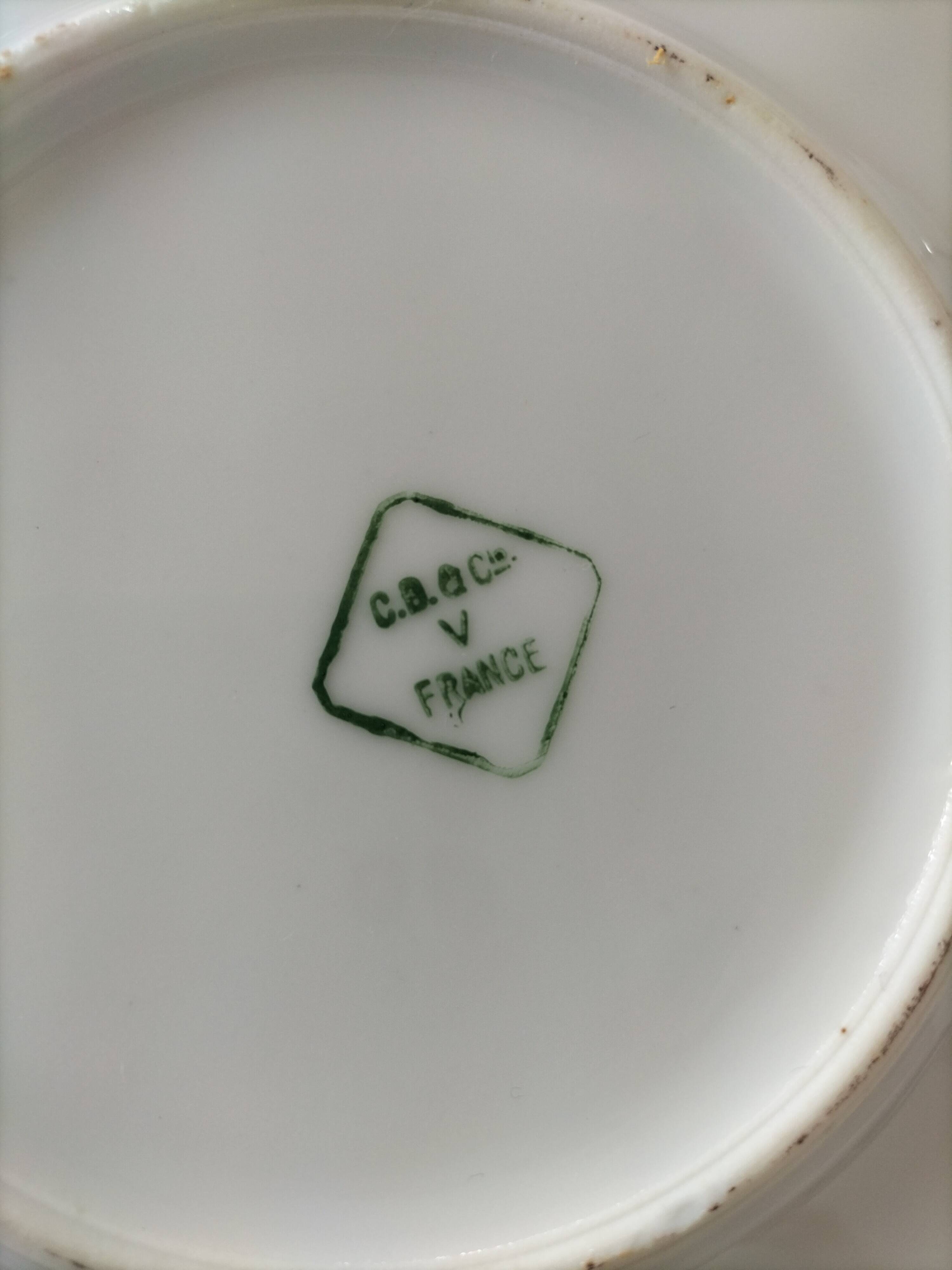 Two Art Deco porcelain cups and saucers with silver trim.