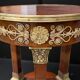 Circular gueridon empire of the 19th century in marquetry ornamented with gilt bronze