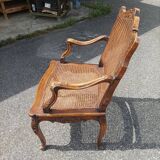 Fauteuil canné sculpté style Régence