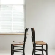 Pair of antique Northern French black-stained chairs with rush seats