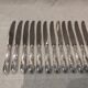 12 silver-plated metal table knives with rocaille ribbon decoration, 25.1 cm