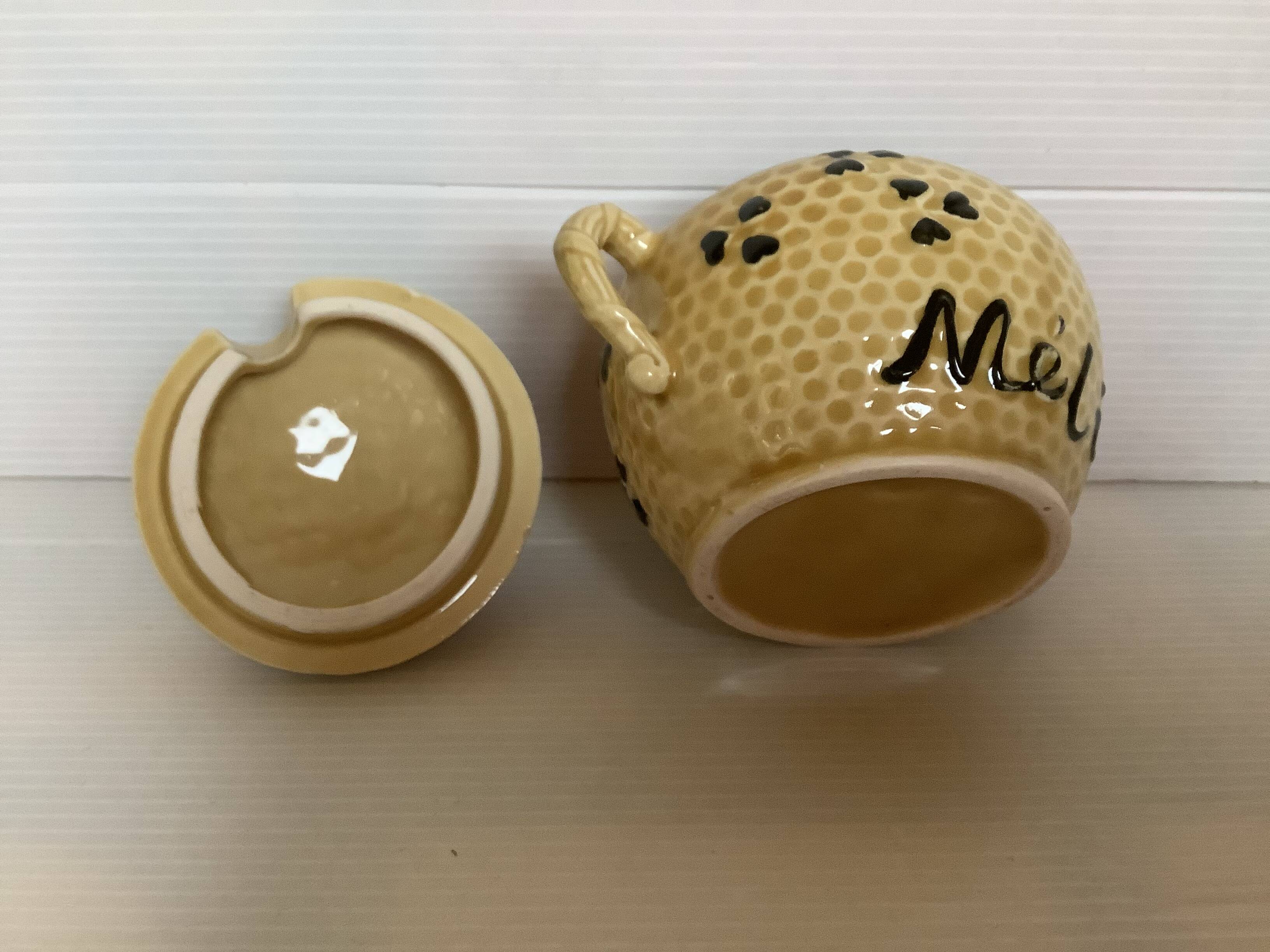 Old honey pot with bee decoration