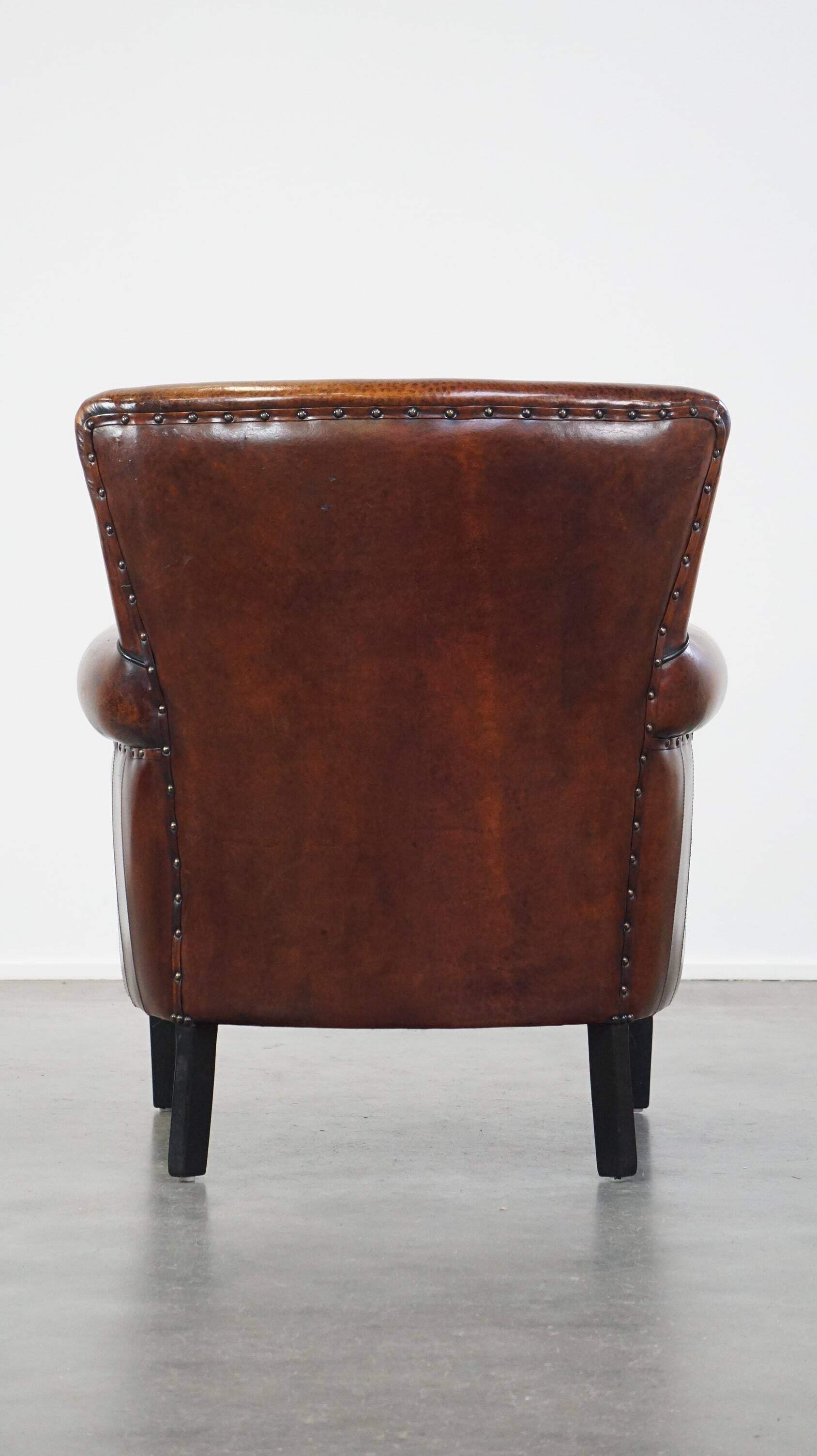 Sheepskin armchair/lounge chair finished with decorative nailheads