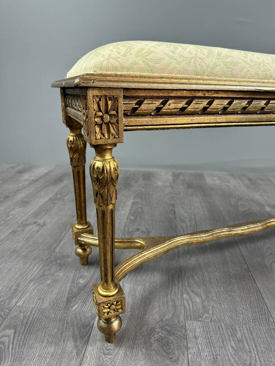 Antique gilded wooden bench in Louis XVI style, 19th century.