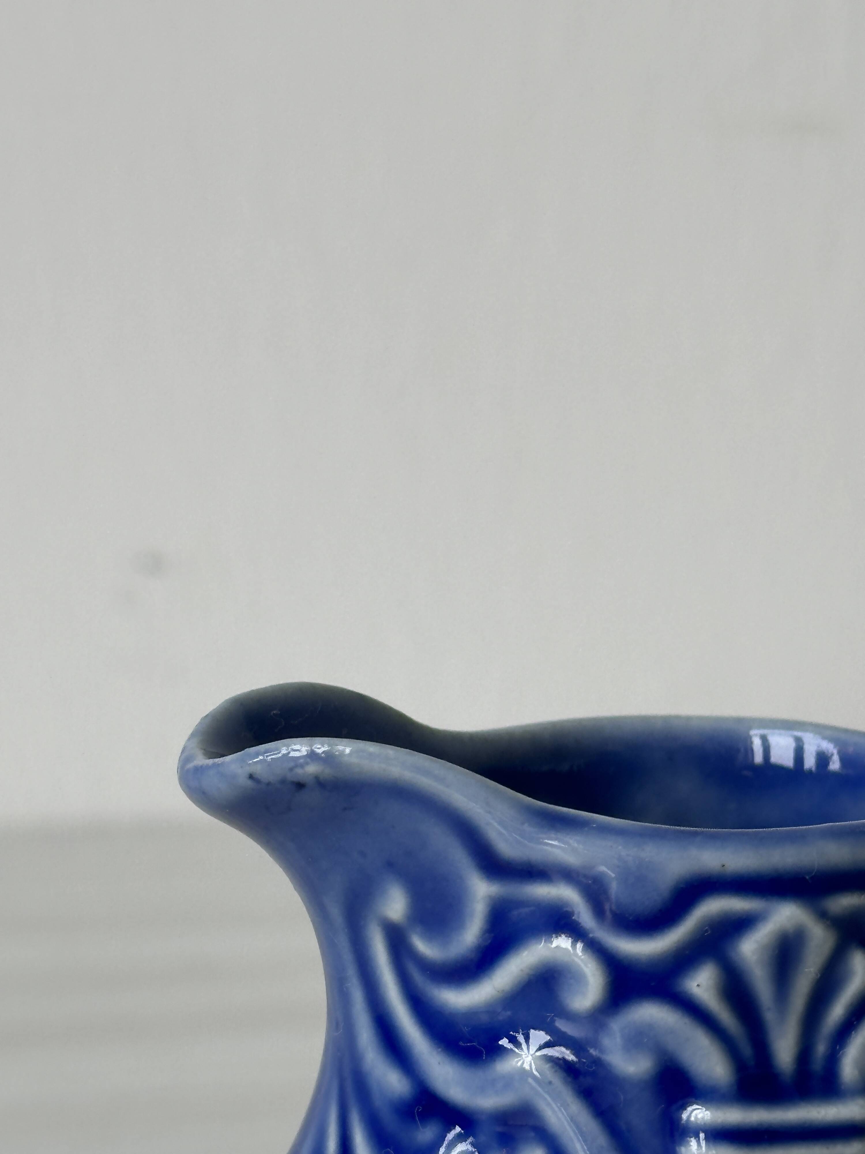 Old cream milk jug in slip