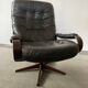 Scandinavian swivel lounge chair in black leather with a bent wood frame, 1970s.